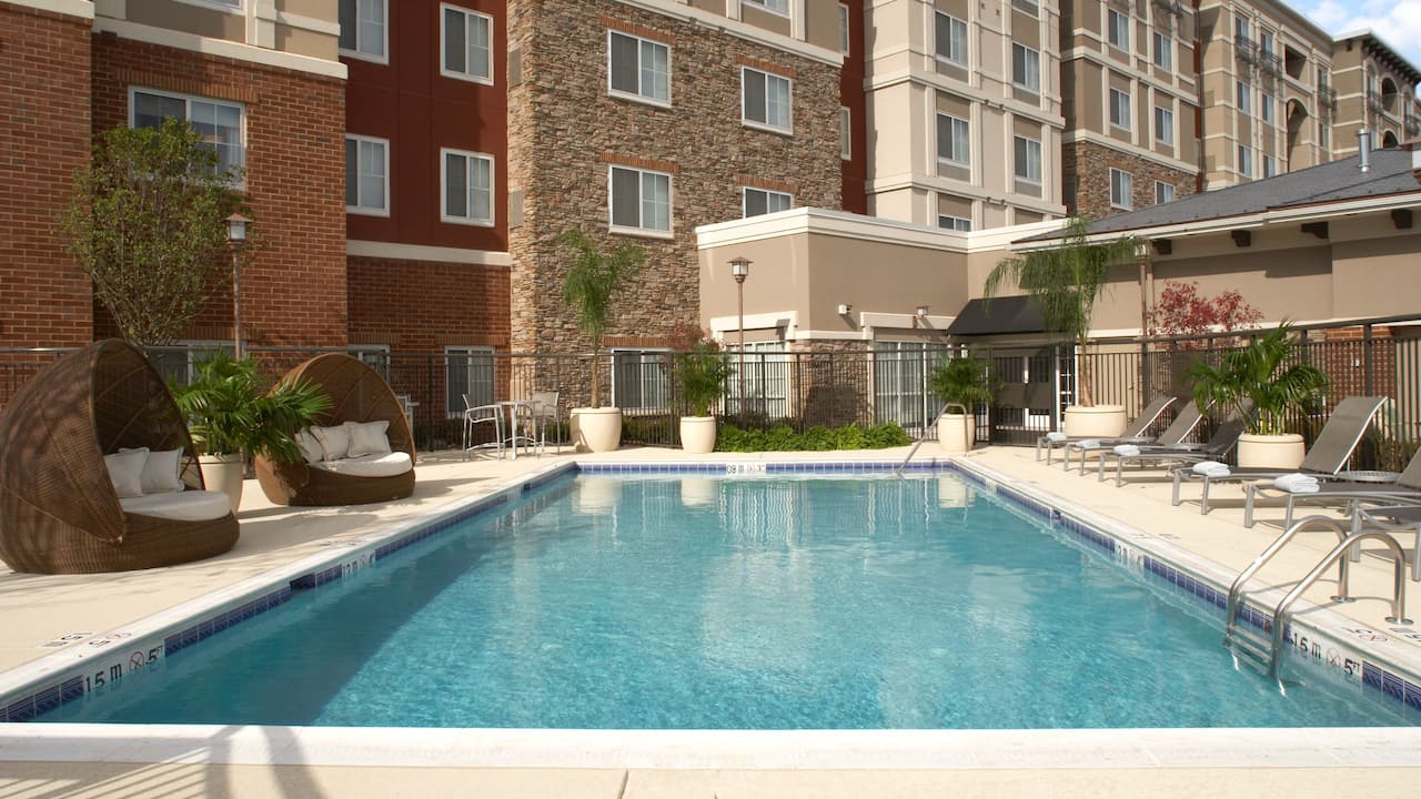 Outdoor pool with ADA lift and pool seating area at Hyatt House Sterling / Dulles Airport – North 