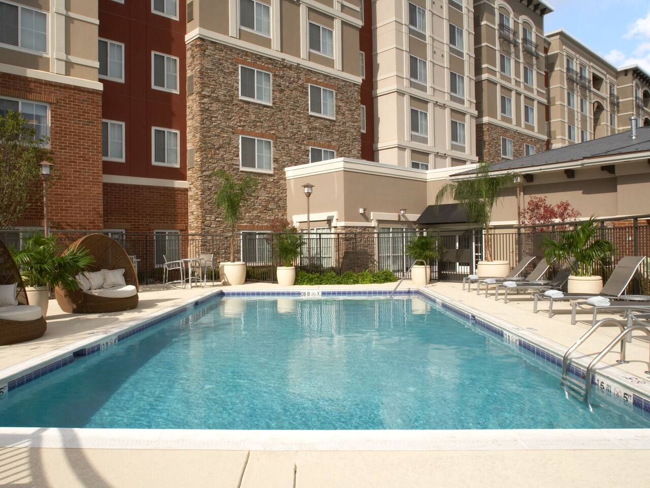 Outdoor pool with ADA lift and pool seating area at Hyatt House Sterling / Dulles Airport – North 