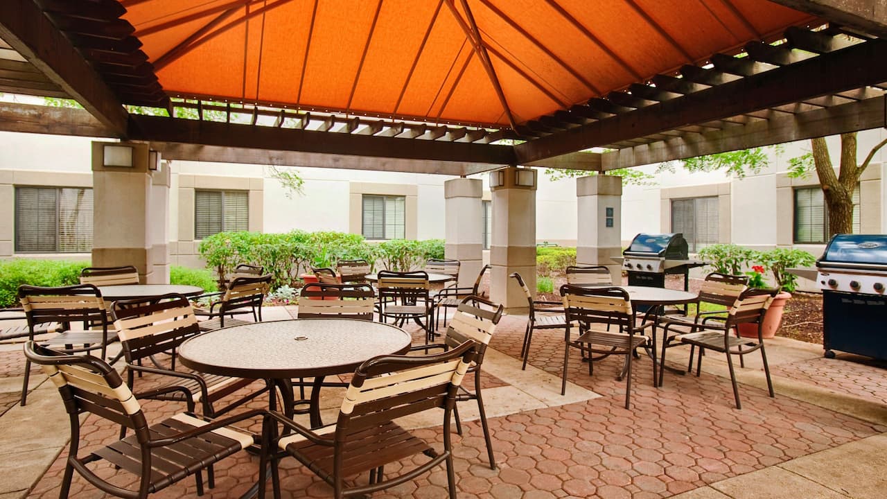 Outdoor covered seating area with BBQ grills at Hyatt House Parsippany / Whippany