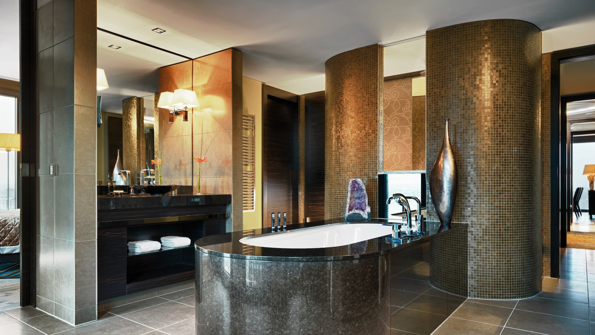 Presidential Suite Bathroom at Hyatt Regency Dusseldorf, with freestanding bathtub, dressing room, sink, and large mirror