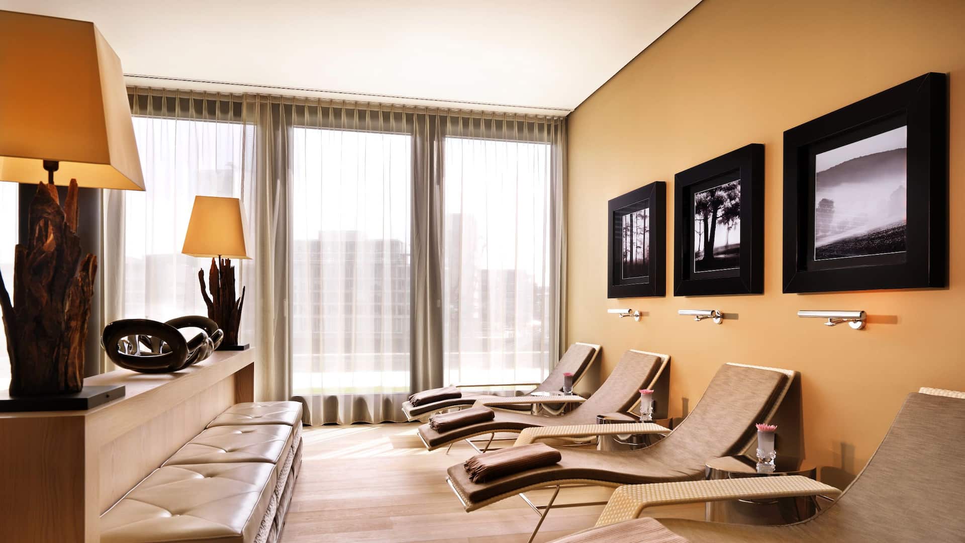Rive Spa at the Hyatt Regency Dusseldorf, with a cozy quiet lounge, equipped with loungers, and floor to ceiling windows