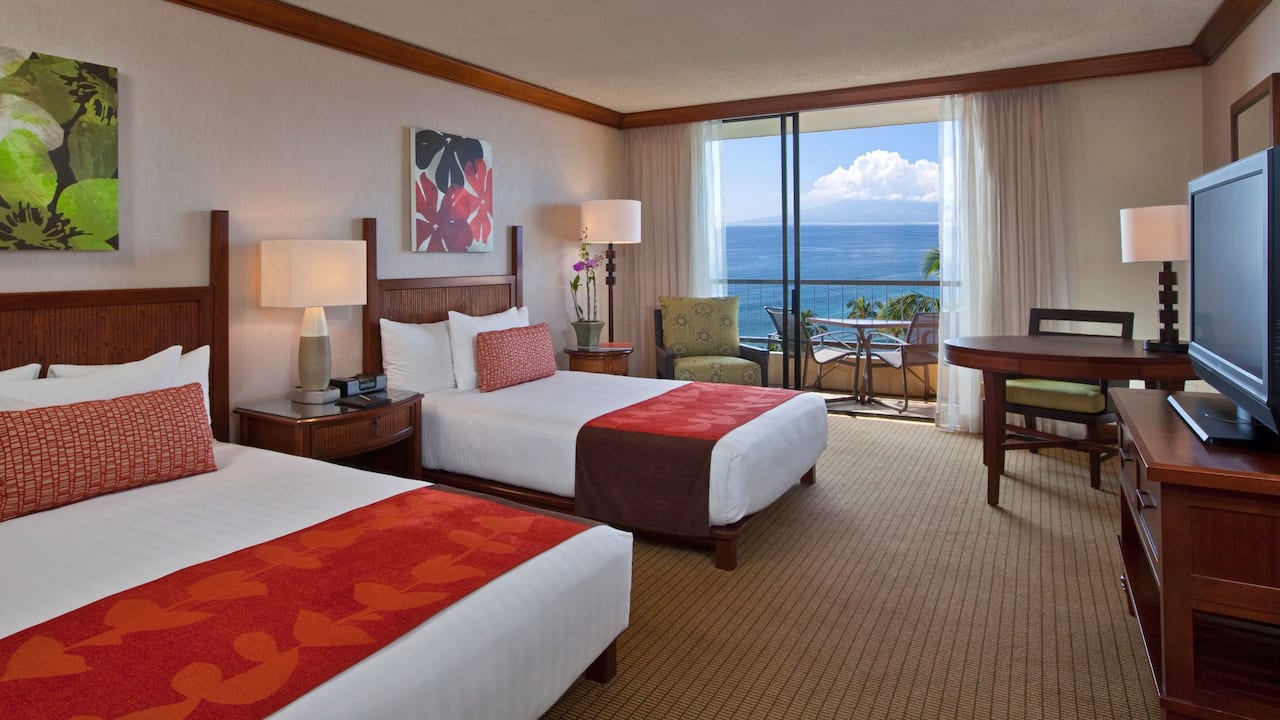 Two beds by large window in hotel room