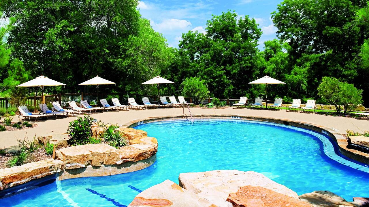Outdoor pool with lounge chairs and sun umbrellas