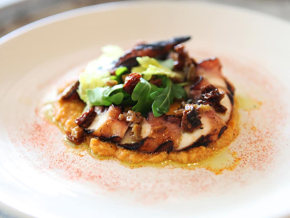 Grilled octopus served on a dinner plate from Borgne in New Orleans