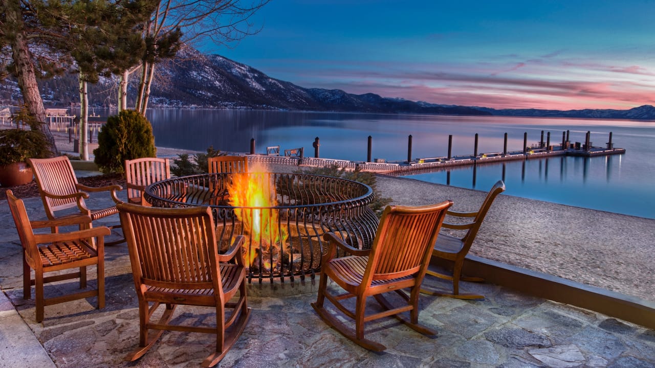Firepit by the lake with mountain view at sunset