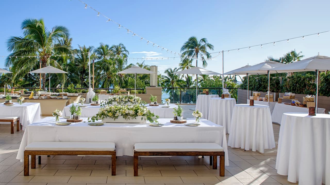Na Lea Terrace with communal table setup and cocktail tables