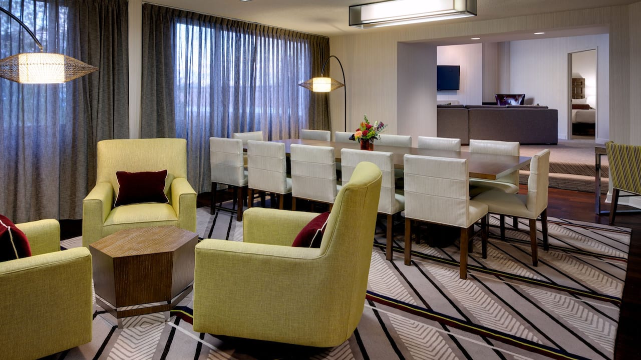 Armchairs, dining table and chairs in hotel suite