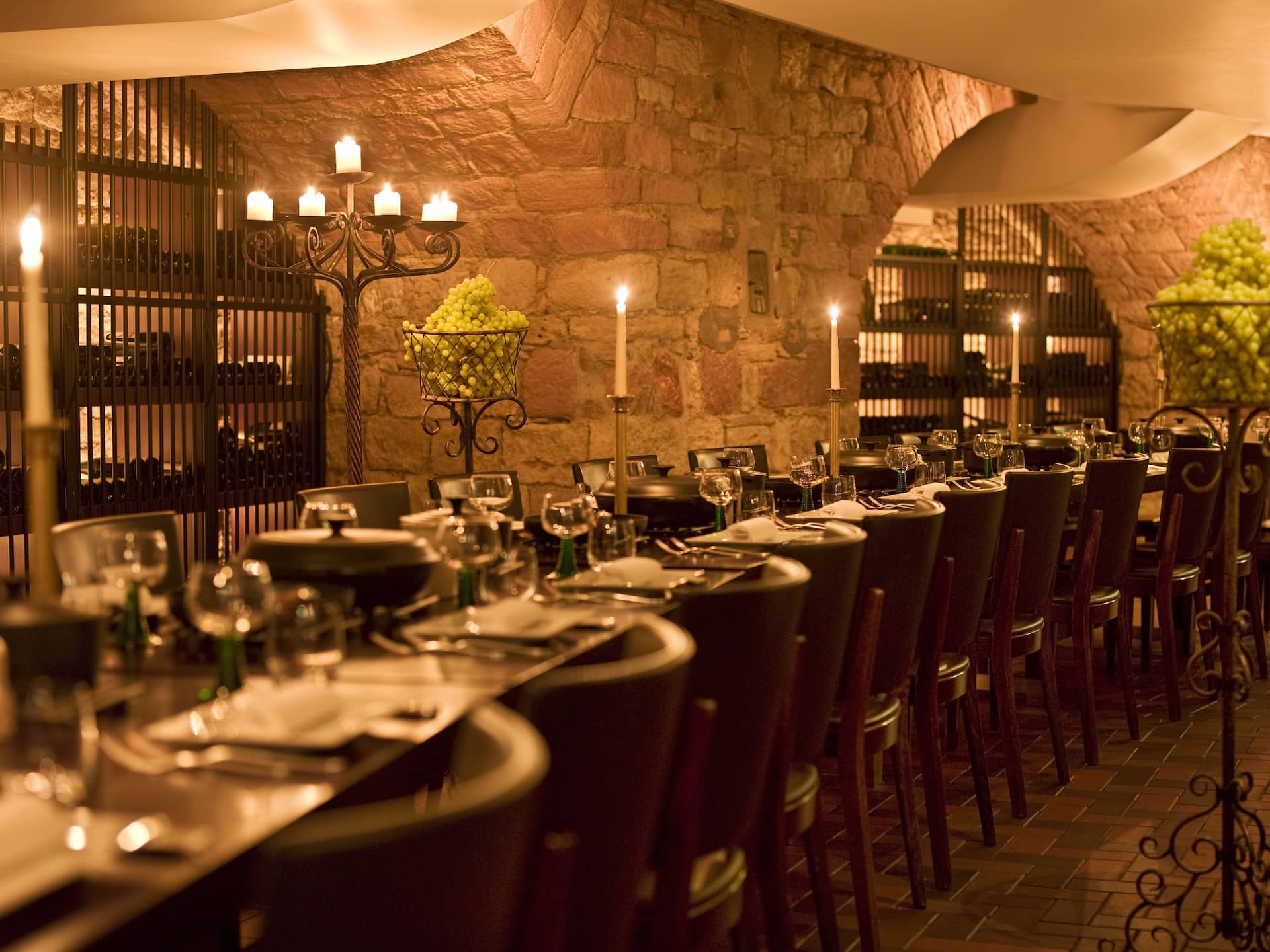 Rustic wine cellar with long table and candles in the Palatorium at Hyatt Regency Mainz