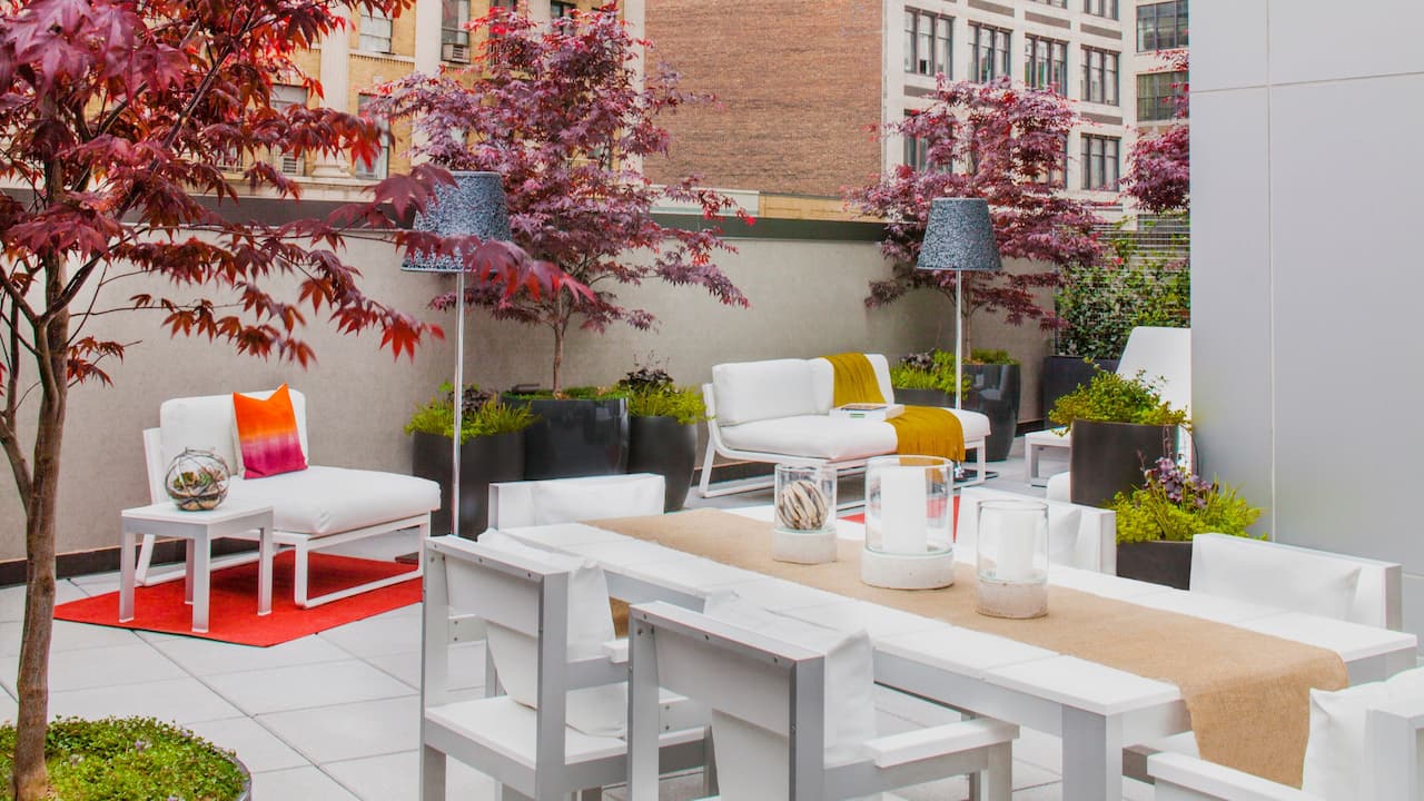 Private outdoor terrace with seating areas and dining table