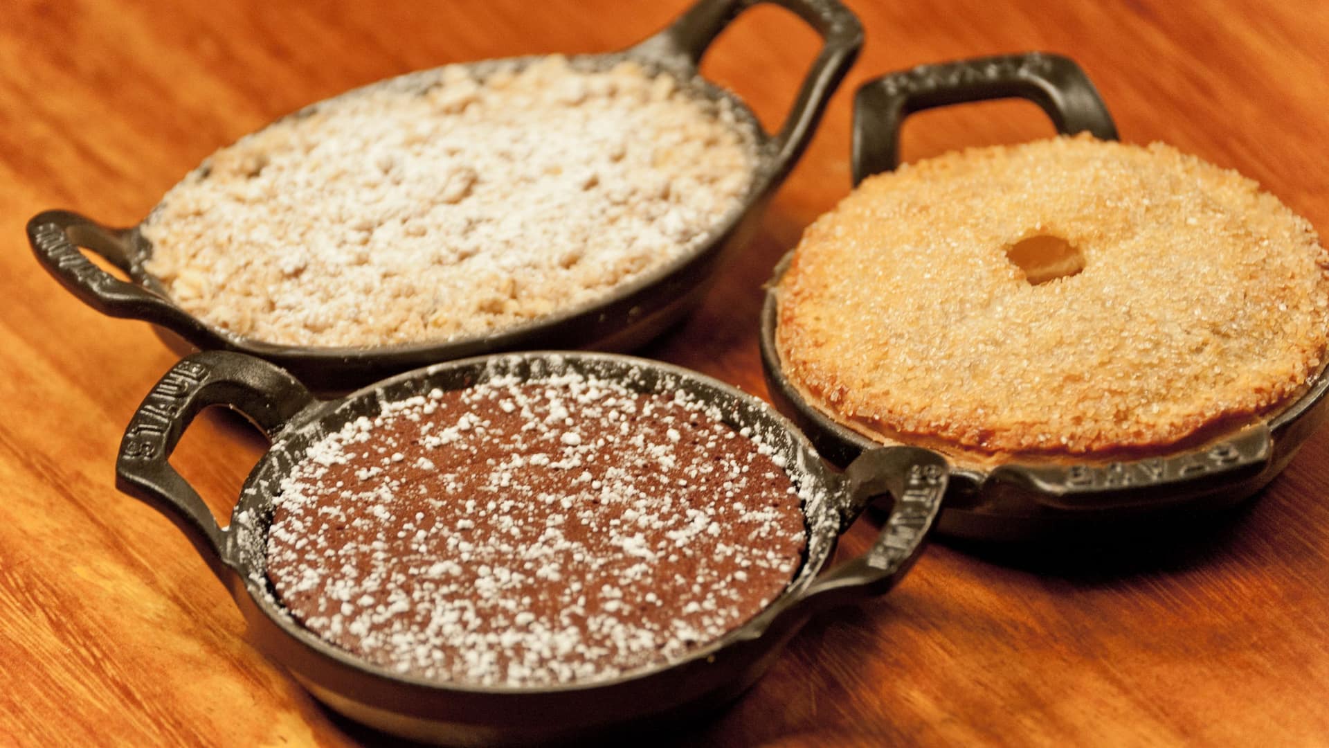 1 of 1 A selection of freshly baked traditional Bulgarian desserts served in cast-iron skillets at Mama Sofia, Hyatt Regency Sofia, showcasing locally curated ingredients and authentic flavors.