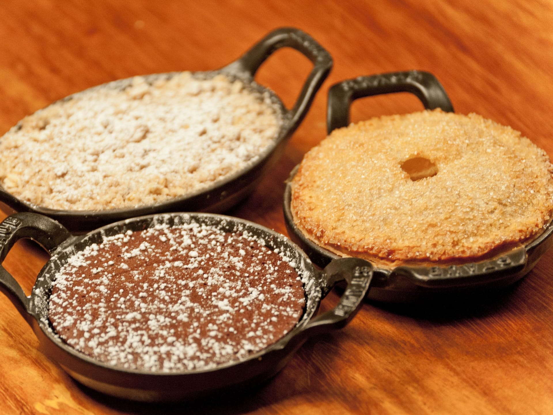 A selection of freshly baked traditional Bulgarian desserts served in cast-iron skillets at Mama Sofia, Hyatt Regency Sofia, showcasing locally curated ingredients and authentic flavors.