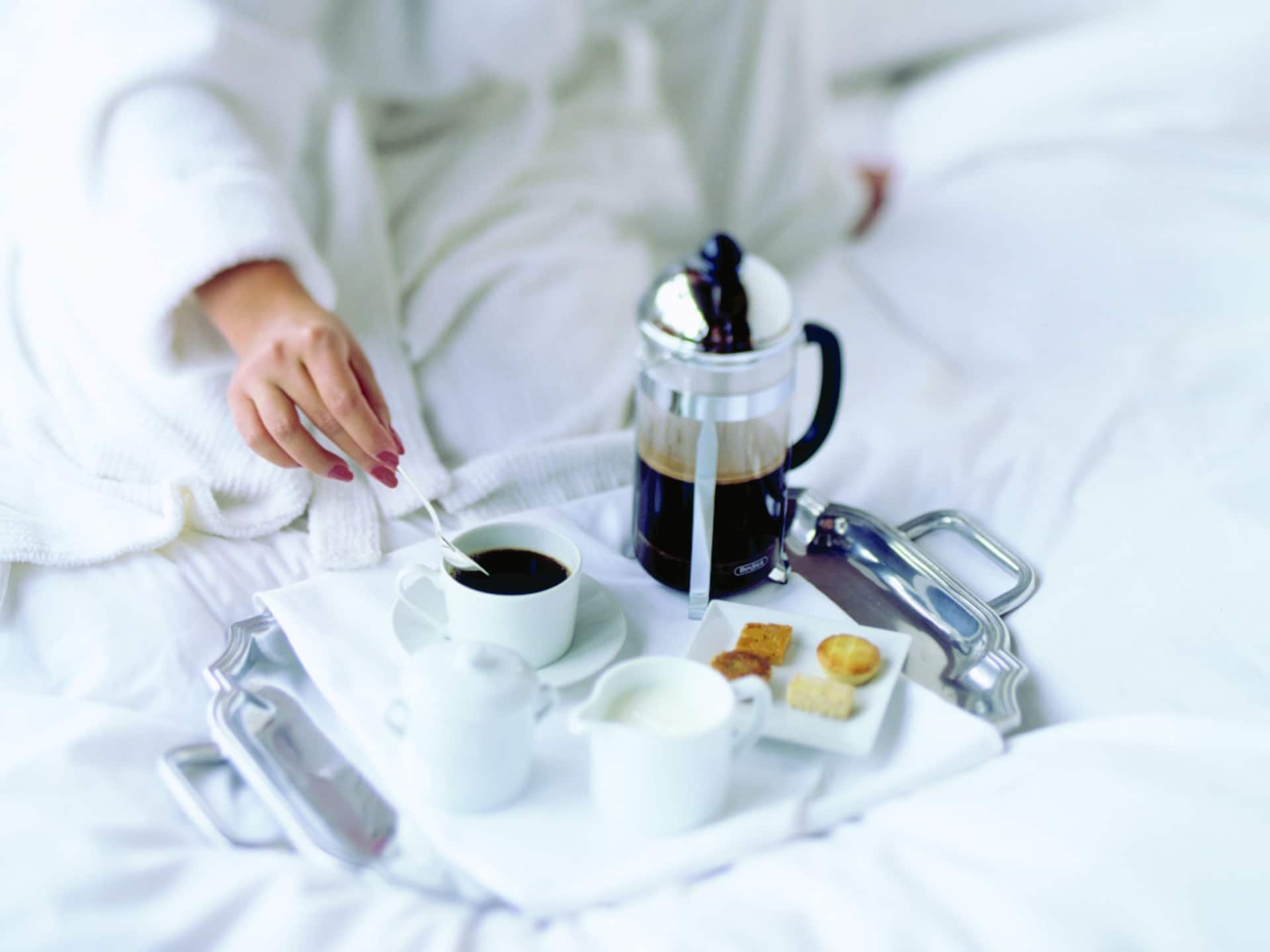 Global Woman in Robe Drinking Coffee