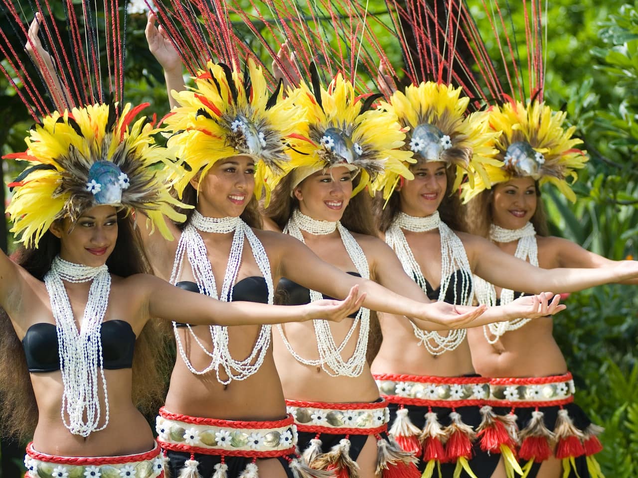 6 Best Kauai Luau Options featured by top Hawaii blogger, Hawaii Travel with Kids: the Grand Hyatt Kauai has one of the best Kauai luau options. Image of Polynesian dancers
