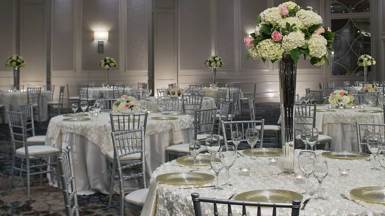 Round banquet tables with custom place setting for a wedding reception