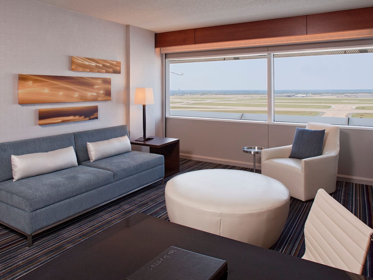 Executive Suite living room with sofa seating and runway view