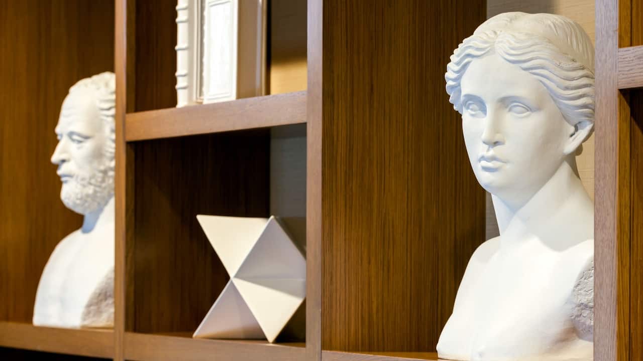 Bookshelf detail showcasing sculpted busts