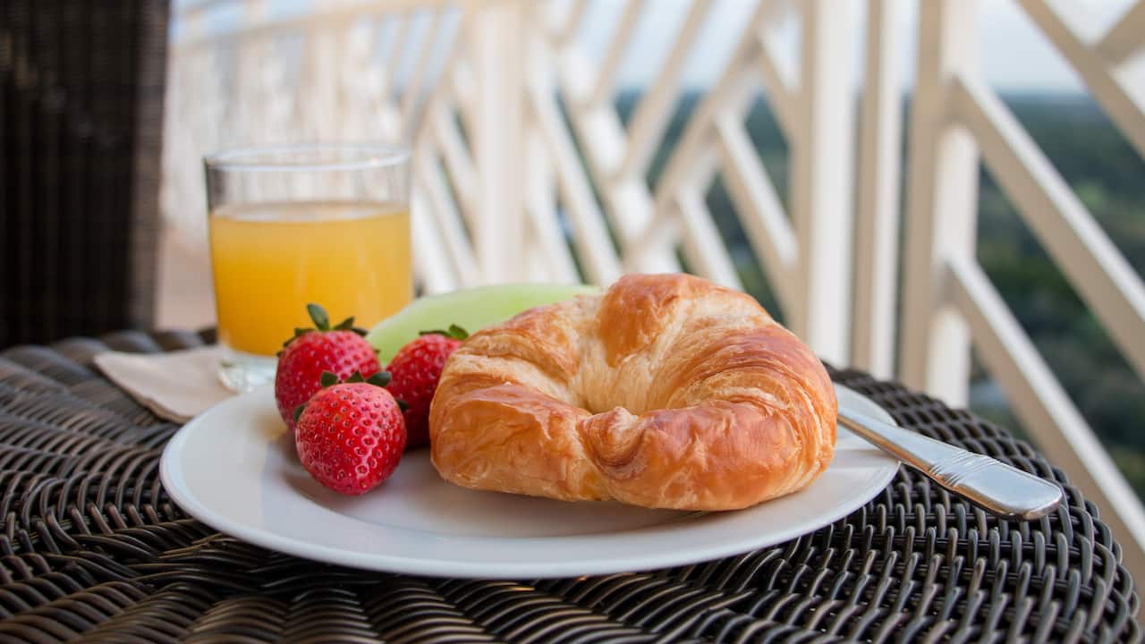 Croissant, fruit, and juice on the balcony of a Bonita Springs Resort