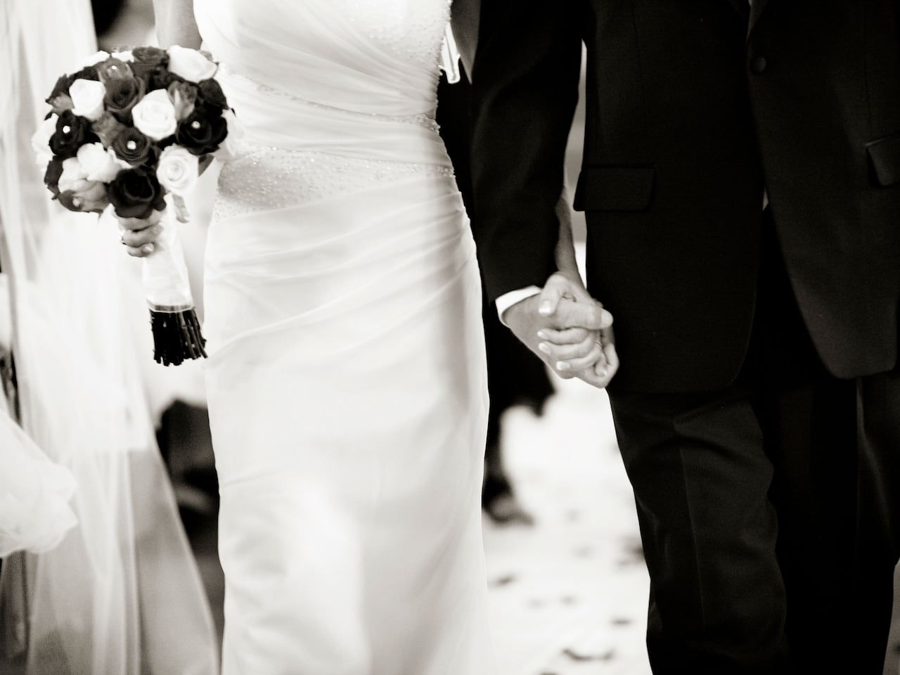 Bride with flowers waling down aisle with man in suit