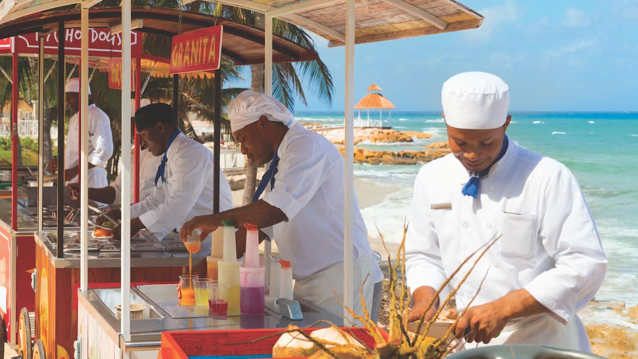 Cooks preparing food at food carts on beach