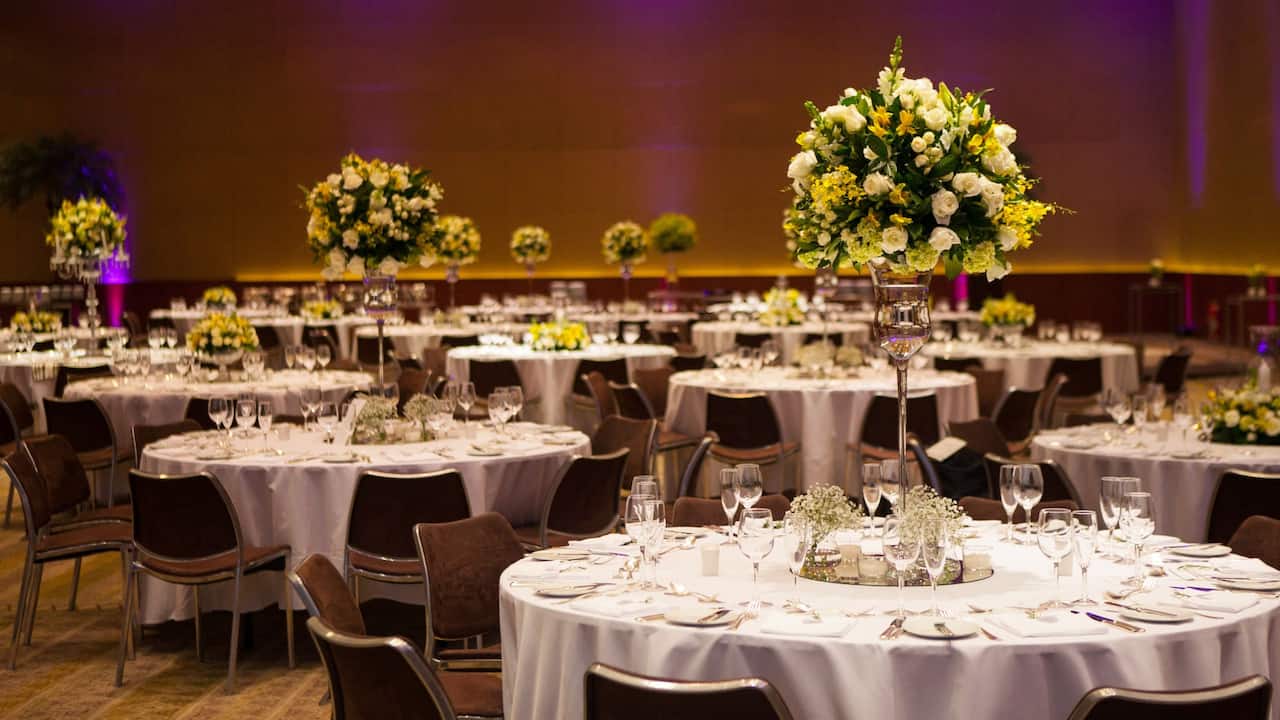 The Grand Ballroom set for a wedding reception with banquet tables and flower arrangements