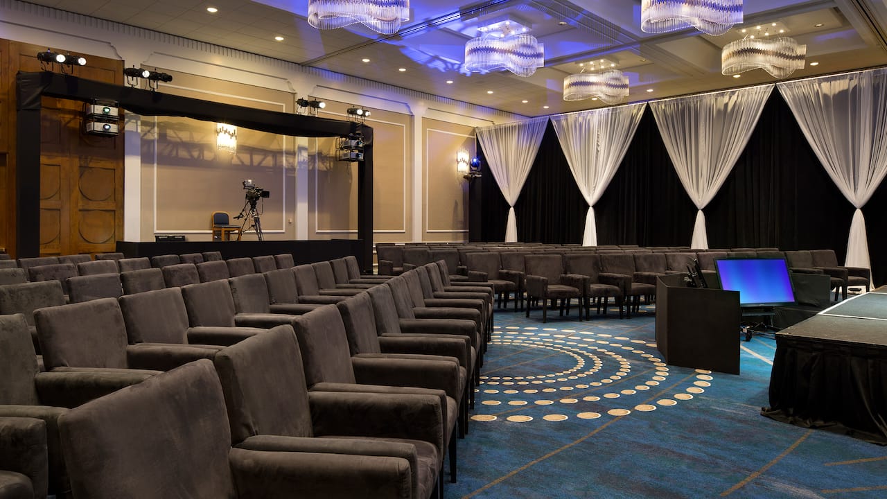 Spacious ballroom with elegant lighting and comfortable seating