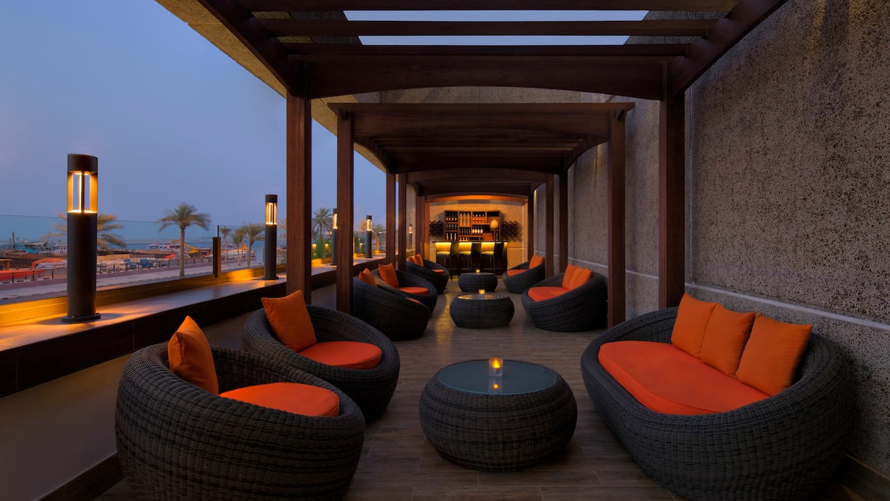 Outdoor couches, chairs and tables on hotel terrace