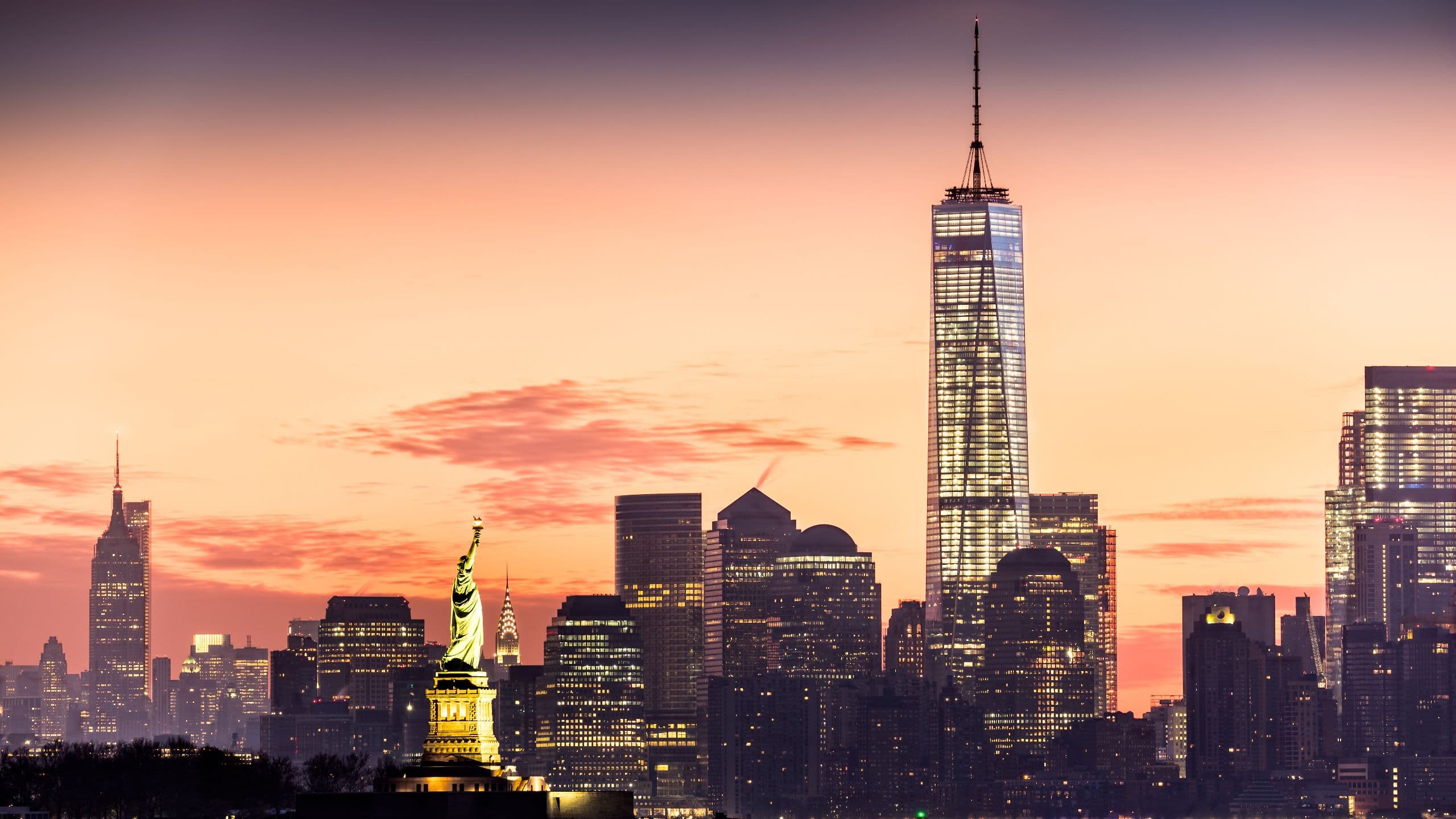 View of the Statue of Liberty and the Financial District at sunrise near Hyatt Centric Wall Street New York