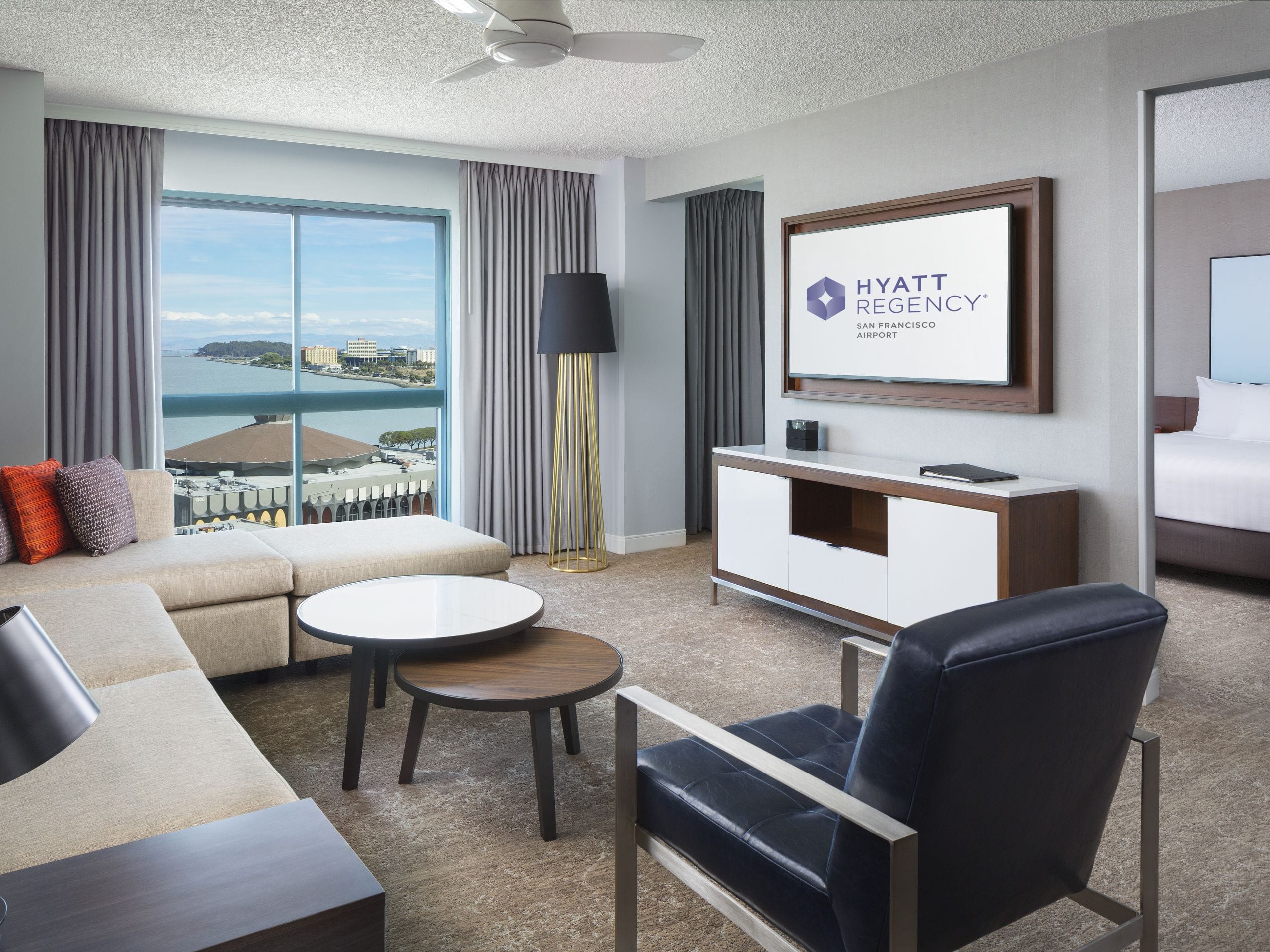 Living room with large window in hotel suite