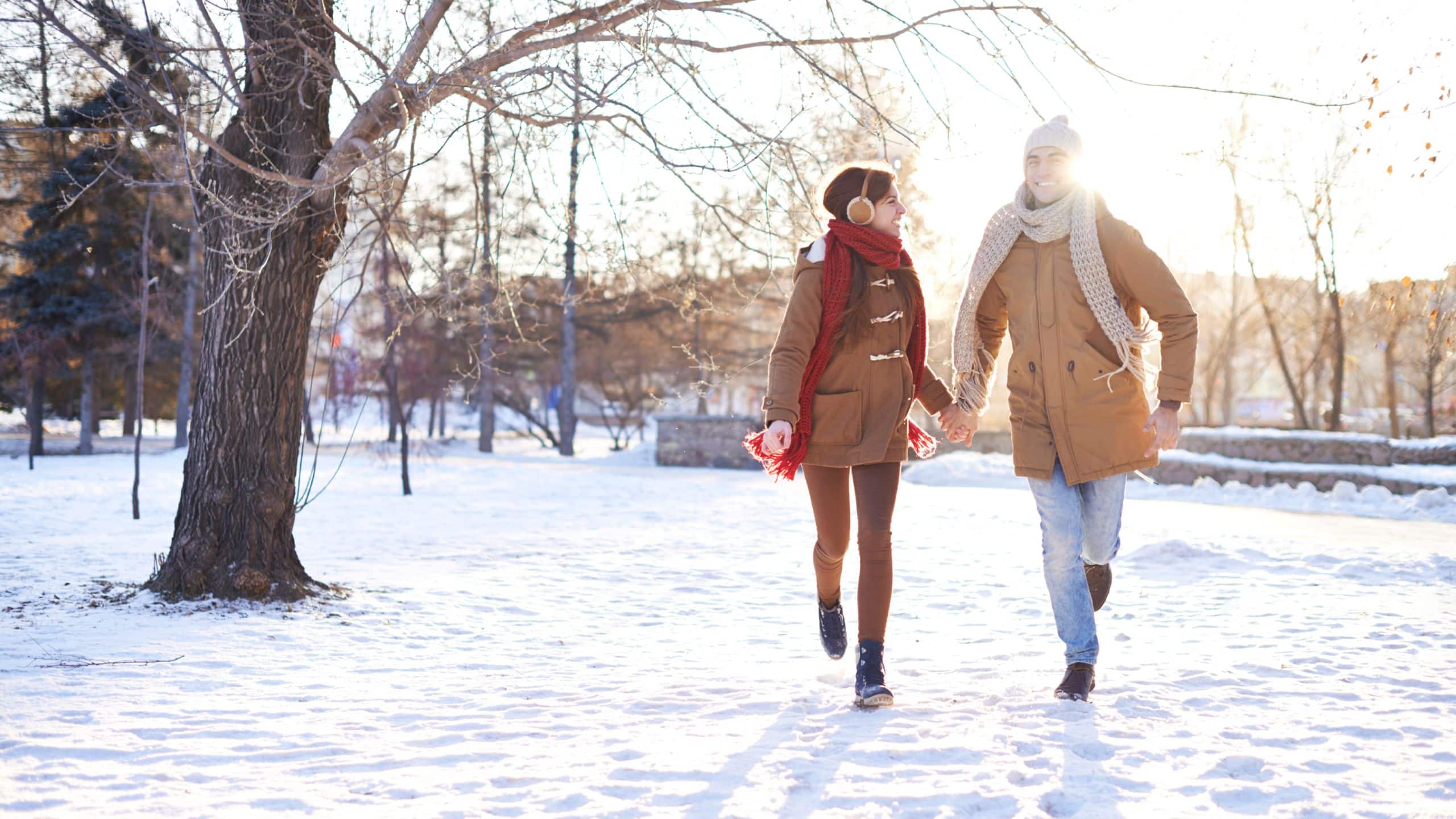 Global Couple Running through Snow