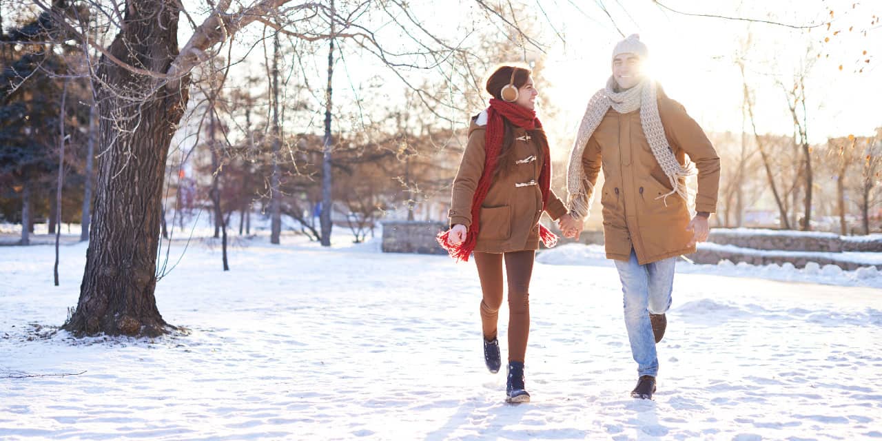 Global Couple Running through Snow