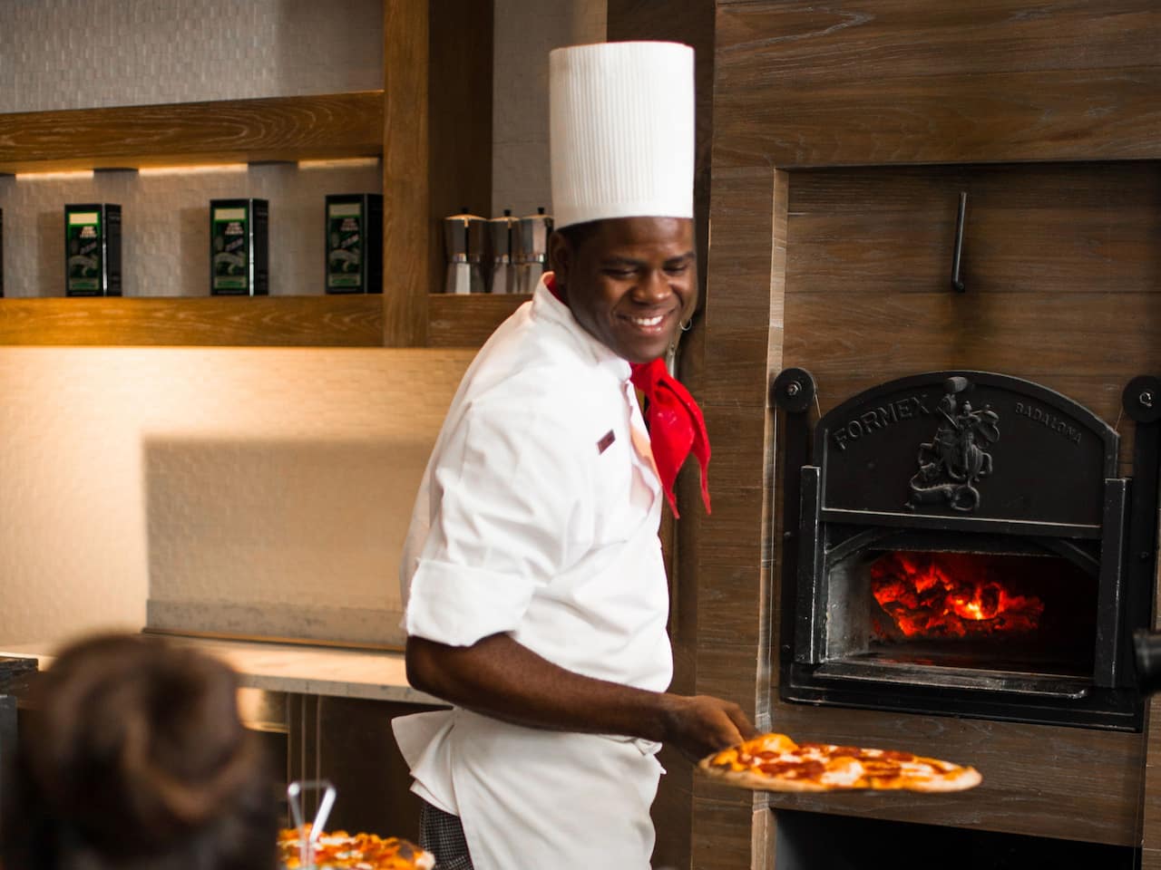 Chef removing pizza from oven at Di RoZa Italian Restaurant at Hyatt Ziva Rose Hall