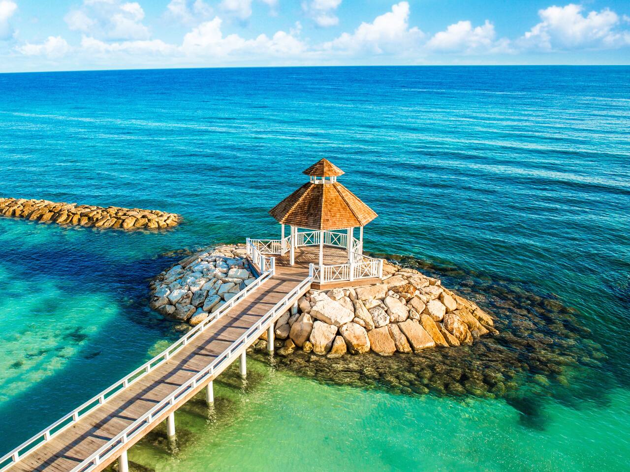 Aeriel view of gazebo at end of long pier on beachfront of Hyatt Ziva Rose Hall