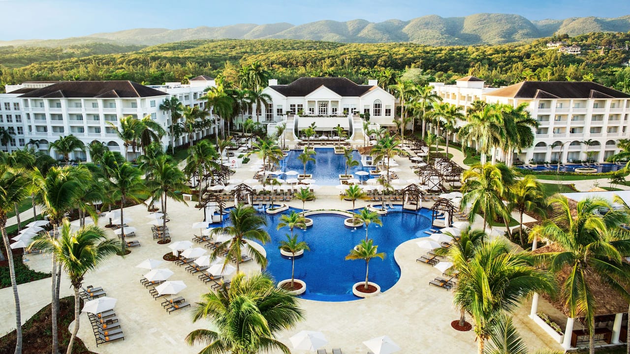 Aeriel view of white buildings, pools, and palm trees at Hyatt Ziva Rose Hall resort 