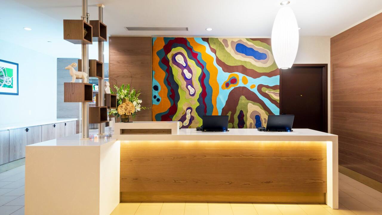 Front desk with a colorful mural