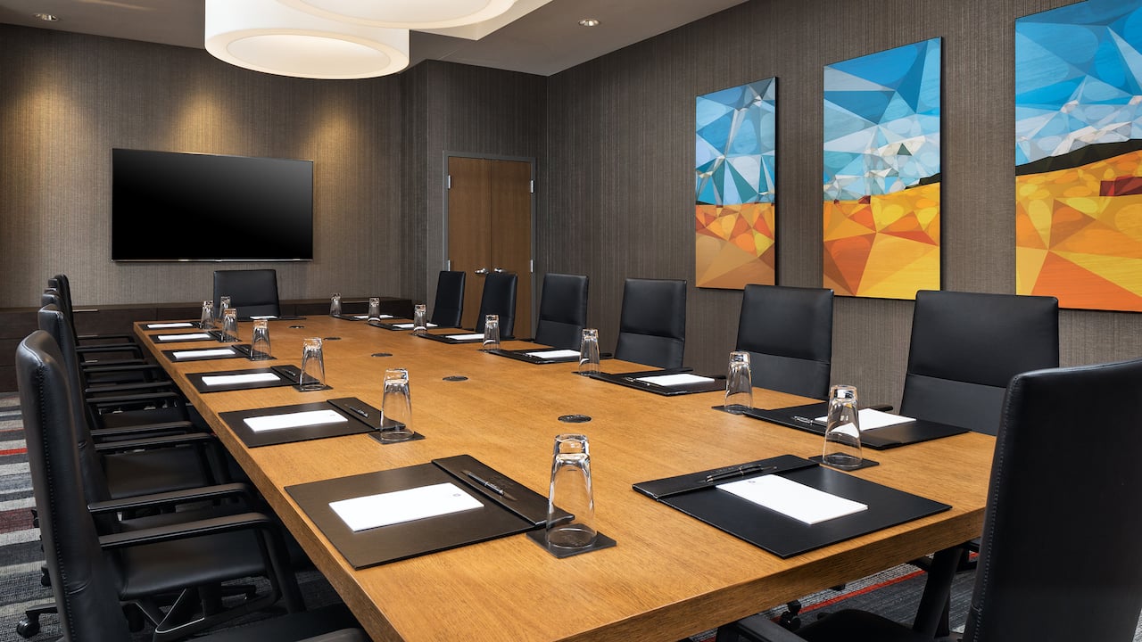 The Interlachen Boardroom with large conference table and mounted television