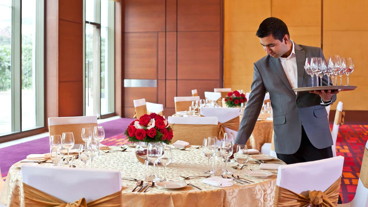 Waiter setting large round table