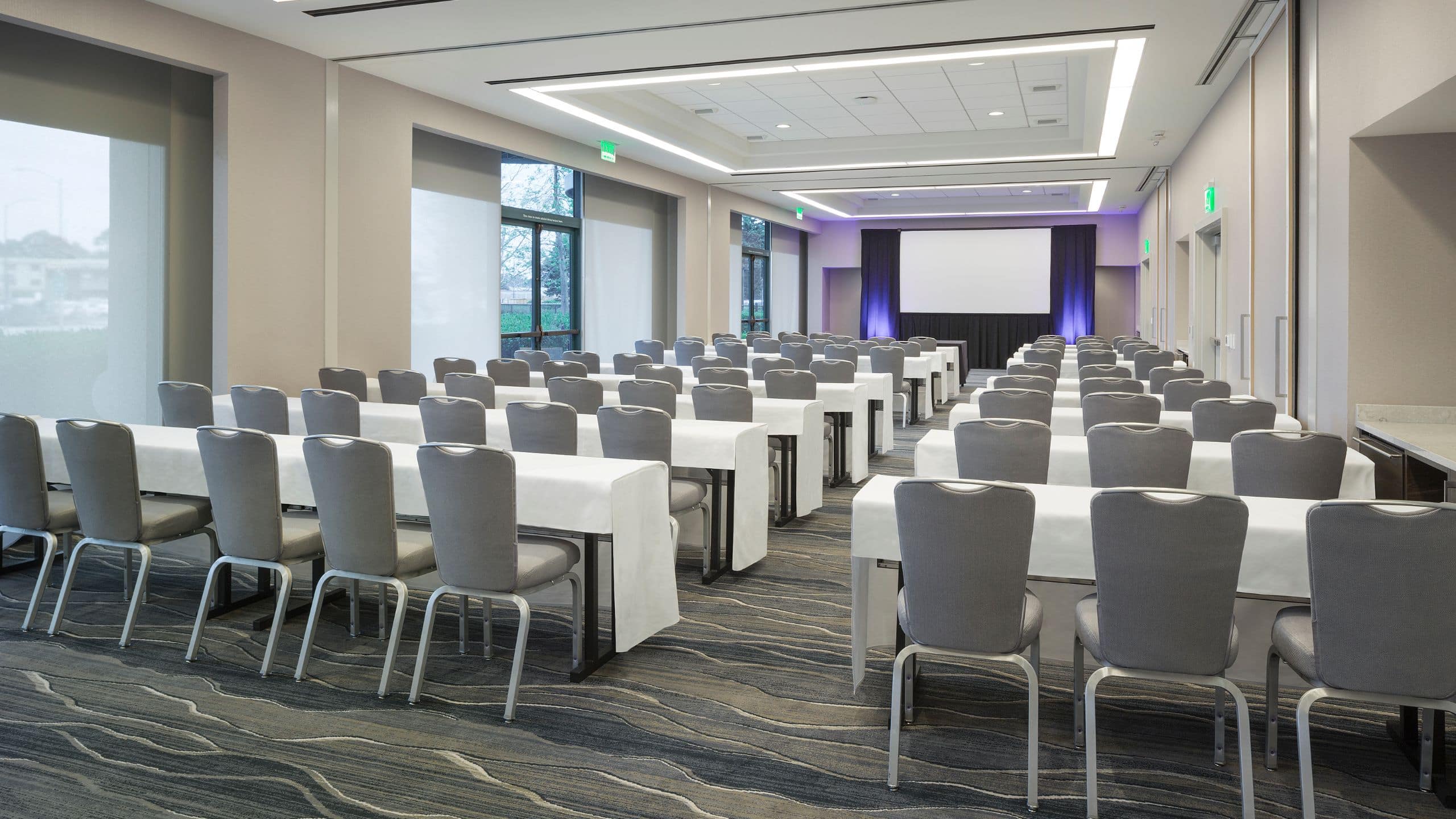 Rows of tables and chairs in ballroom classroom setup