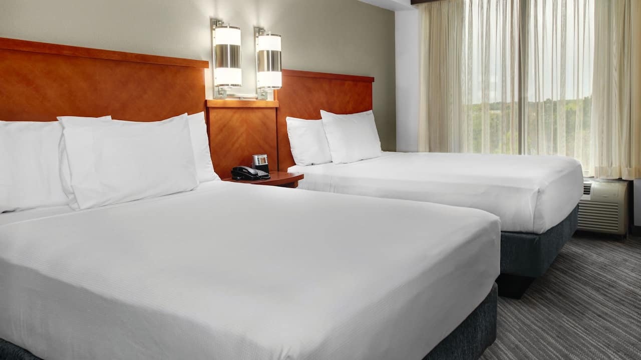 Double queen beds in guestroom at hotel near Norcross