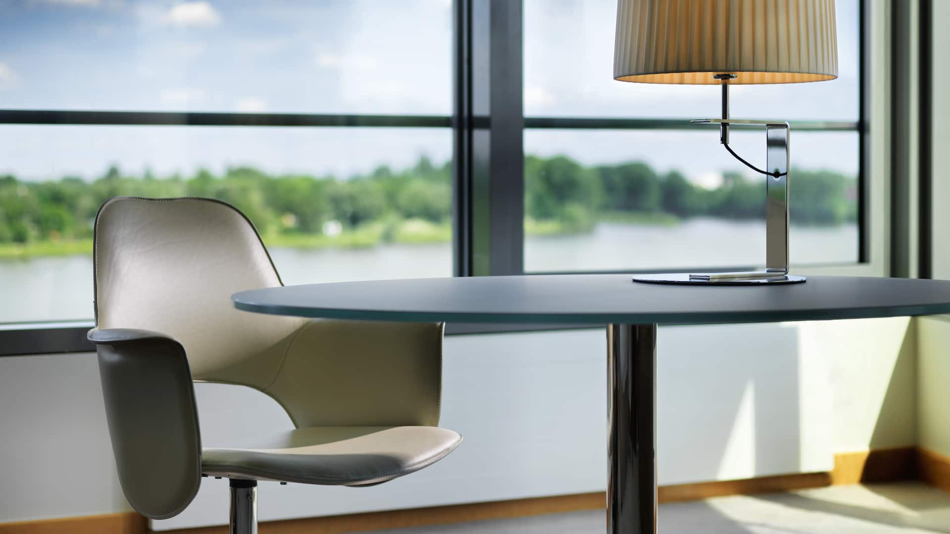 Desk in guestroom of Hyatt Regency Mainz with in front of window with views of the Rhine river