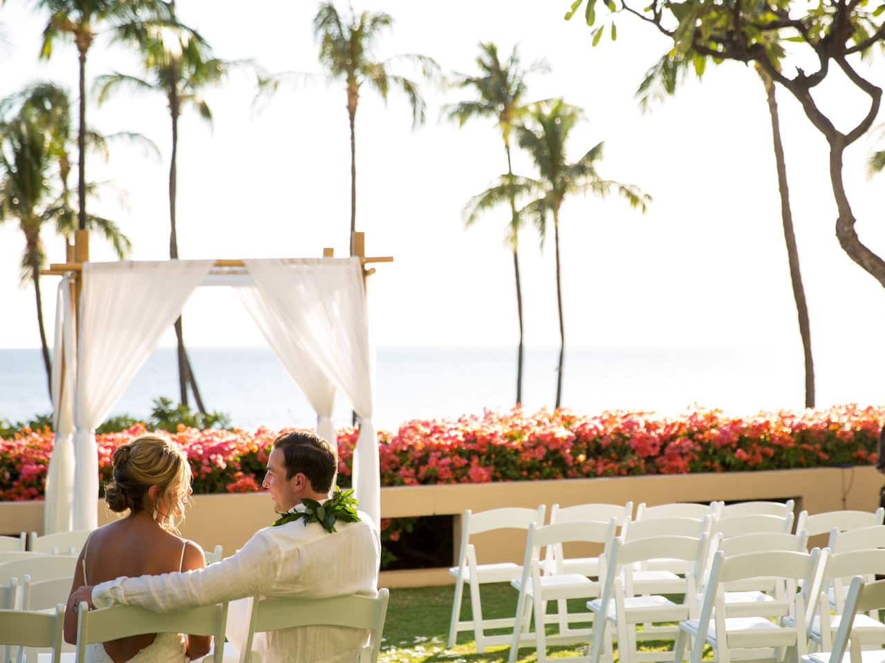 Married couple sitting in their wedding area at Hyatt Regency Maui