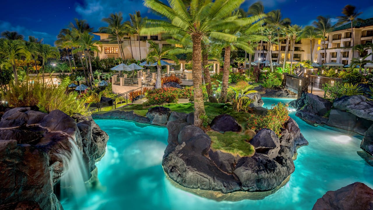 Outdoor river pool at night at Grand Hyatt Kauai Resort and Spa