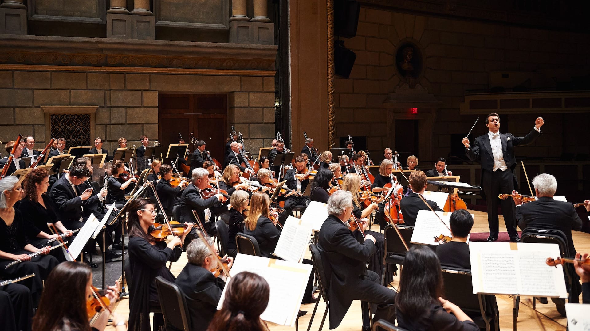 Philharmonic orchestra performs in theater hall