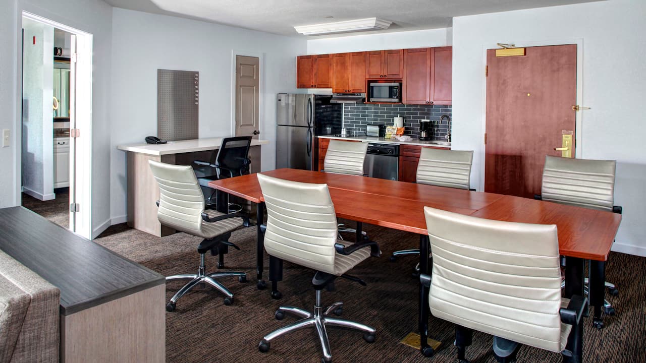 : Fully equipped kitchen with conference table set with six chairs, and desk with swivel chair.