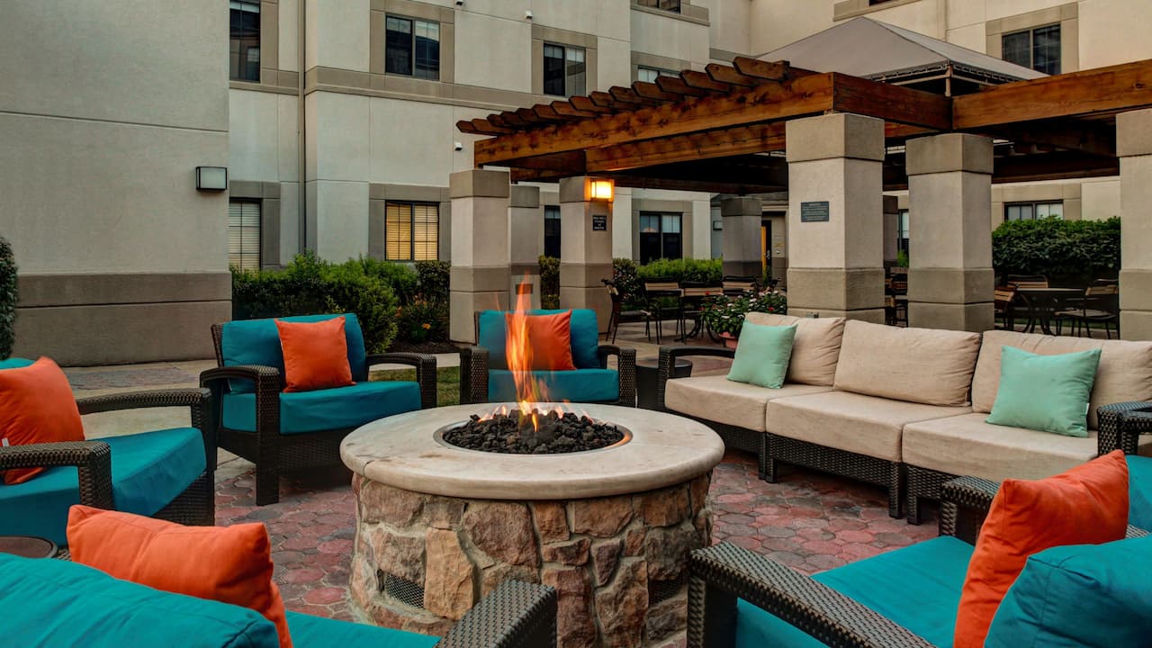 Morristown hotel outside seating area with firepit at Hyatt House Morristown