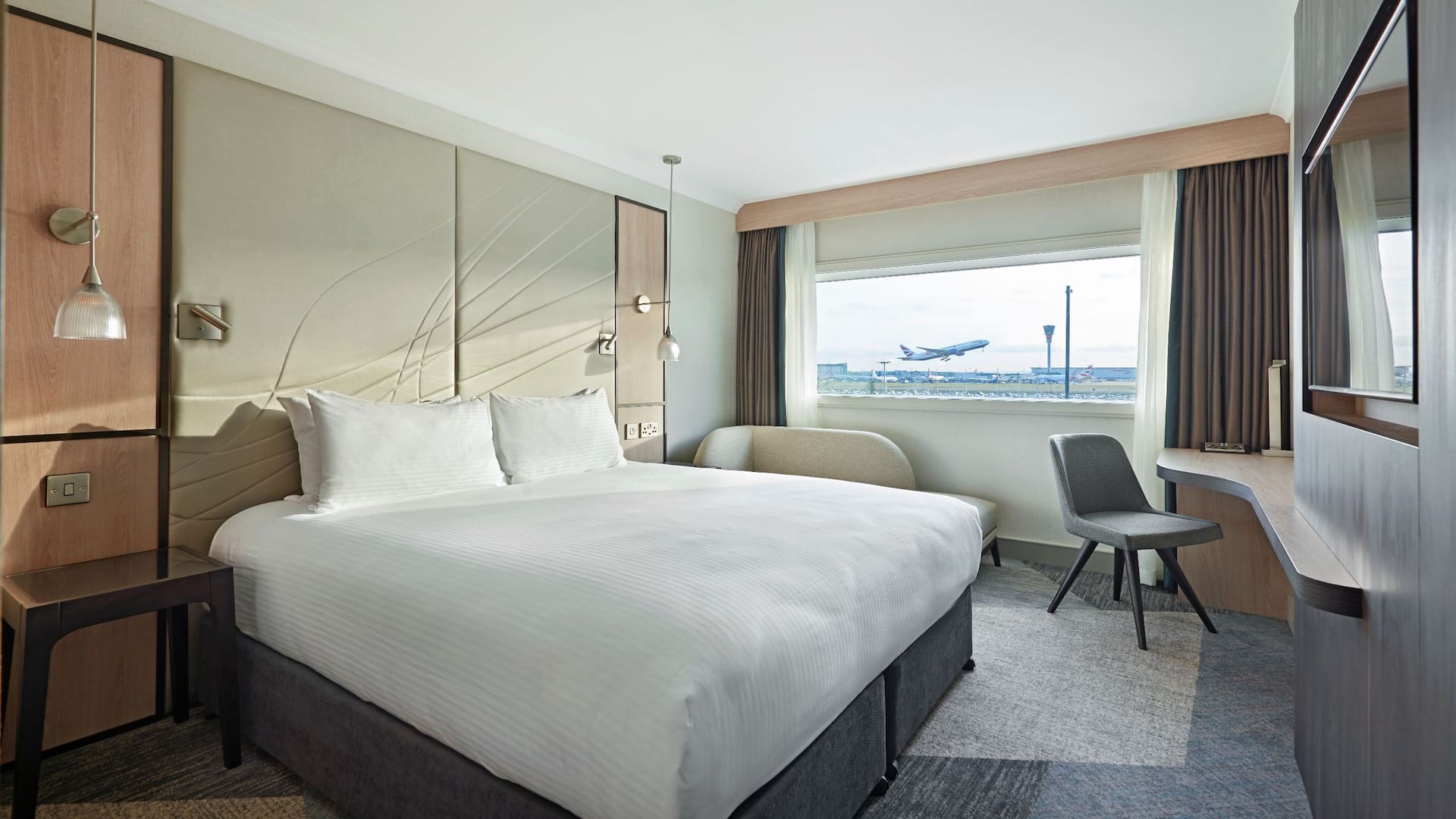 Bedroom overlooking a plane taking off at Heathrow airport