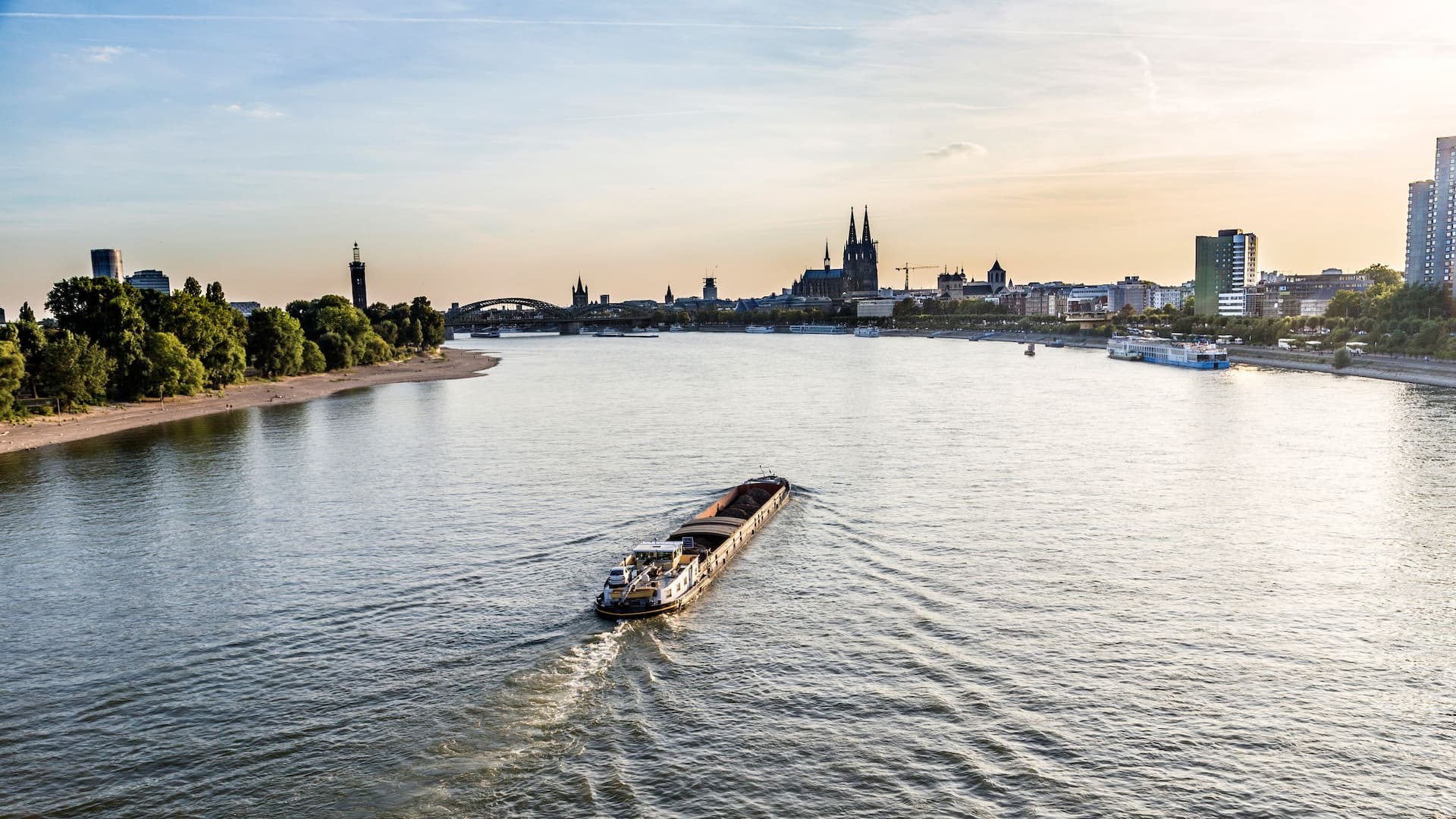 Ship sails along the Rhine past Hyatt Regency Cologne