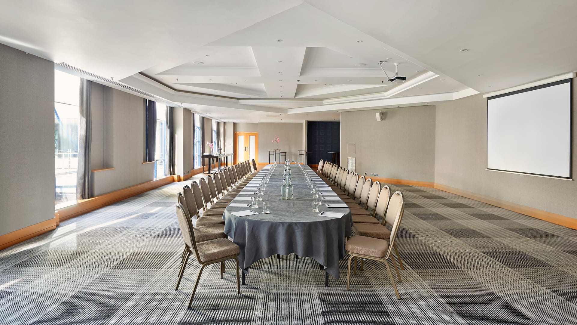 Boardroom setup with natural daylight and projector at Hyatt Regency Birmingham