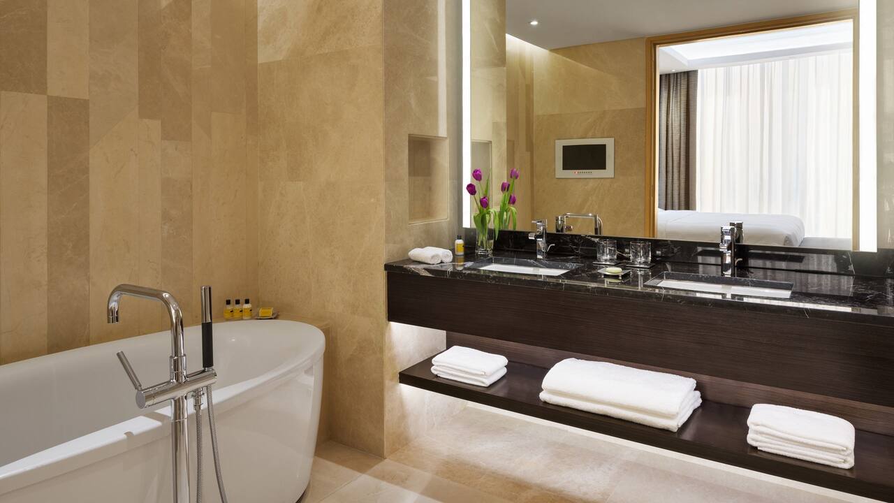 Beige marble bathroom in hotel suite
