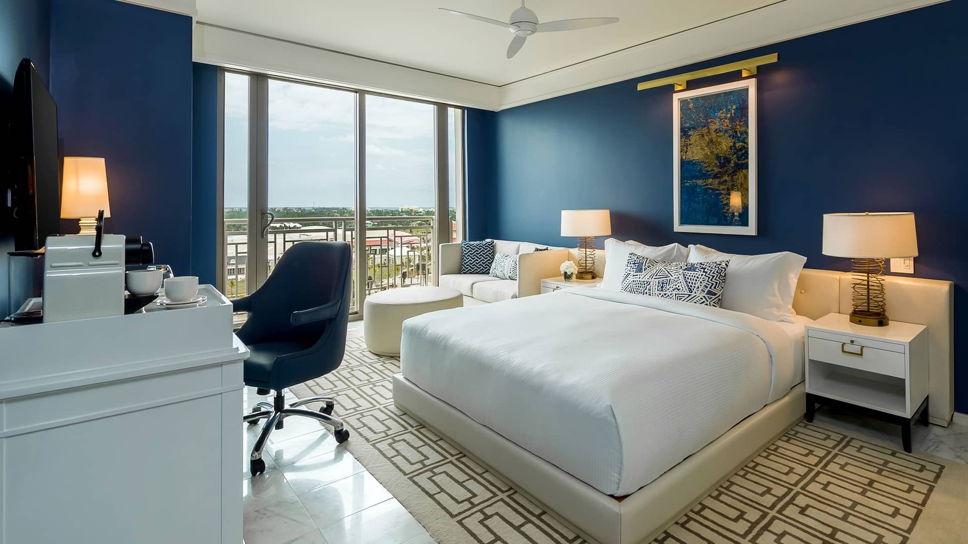 3/4 A spacious king hotel resort bedroom with a balcony view of the nightly fountain show in Nassau Bahamas