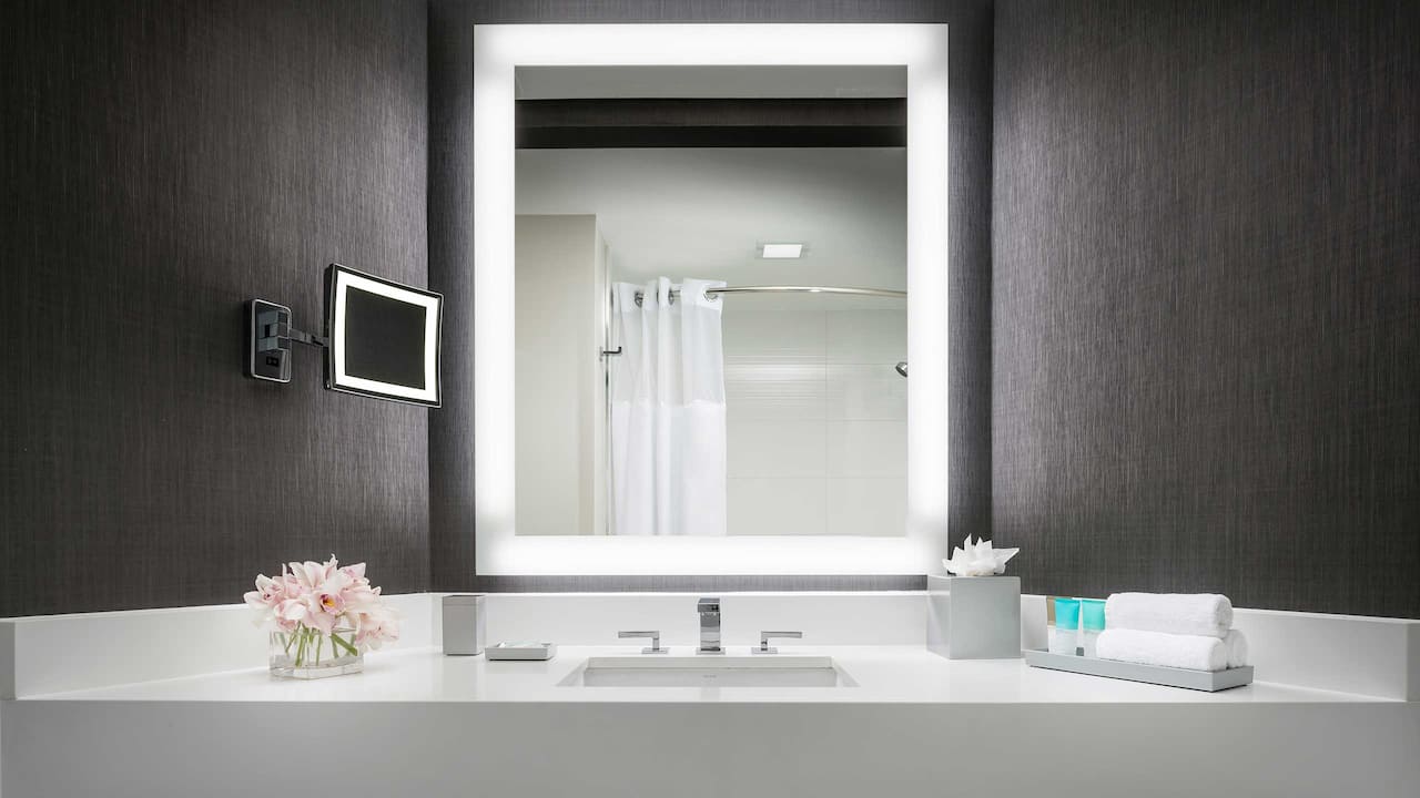 Guest bathroom vanity with lighted mirror 